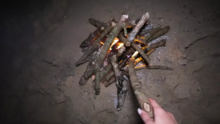 Bj and doggy on the beach at night by the fire